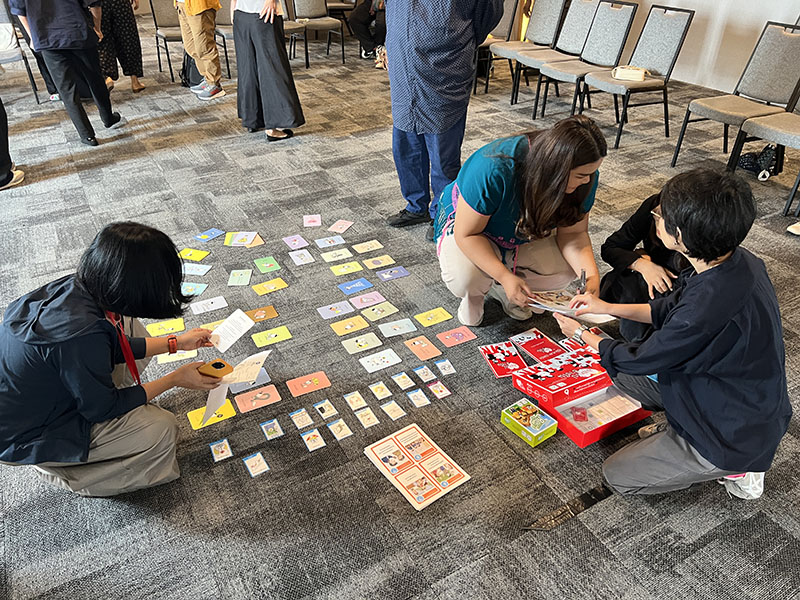 Participants play board games, to learn and enjoy. After activities they provide feedback for improvement.